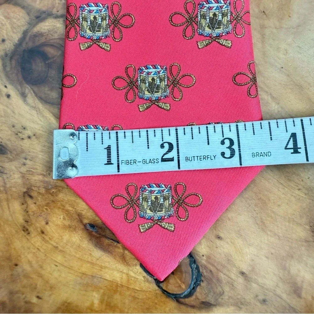 Vintage Hermès red silk tie with a repeating drum motif 3.5” x 54”